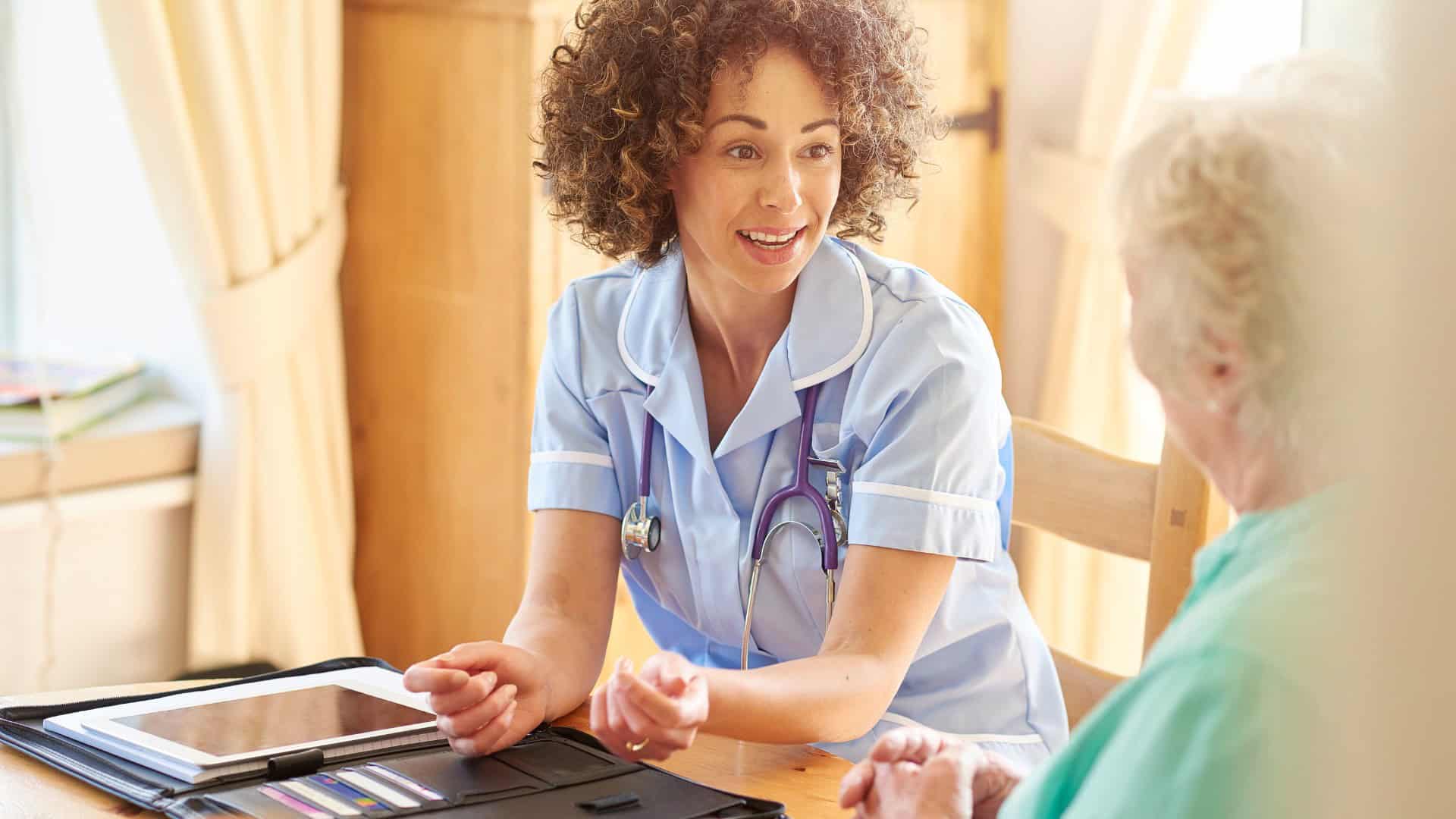 Female healthcare worker assessing older lady