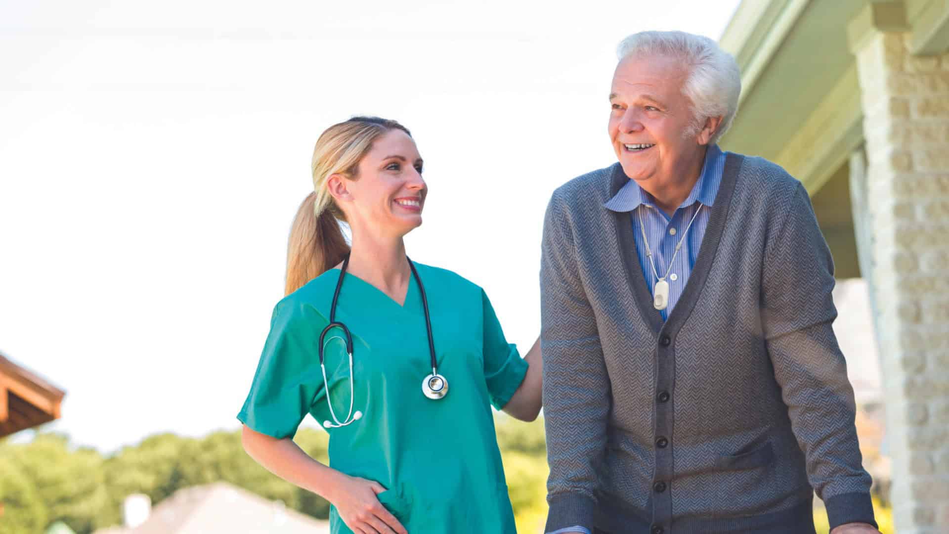 Older man smiling and wearing Lifeline button