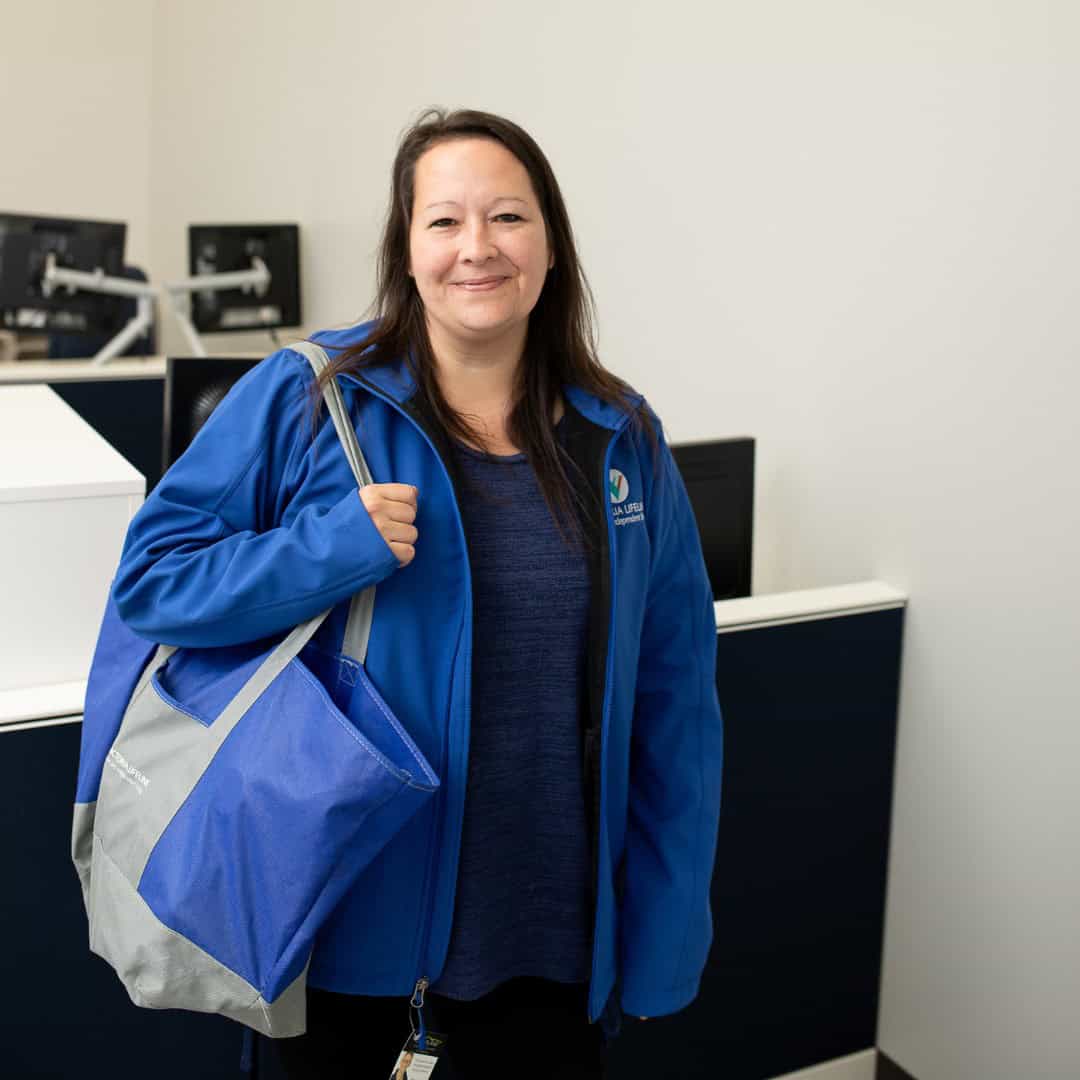 Victoria Lifeline Employee Holding Bag Victoria Lifeline Employee Holding Bag
