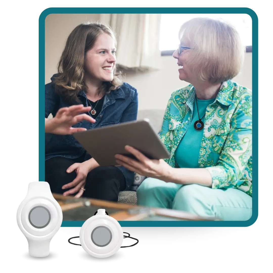 Two women talking with one wearing HomeSafe button
