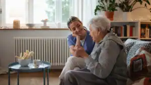 Older women sitting next to Home Care worker